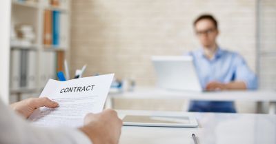 Employment contract being reviewed across a desk
