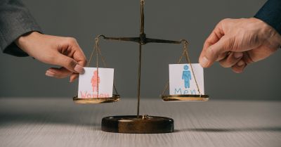 Scales balancing female and male figures