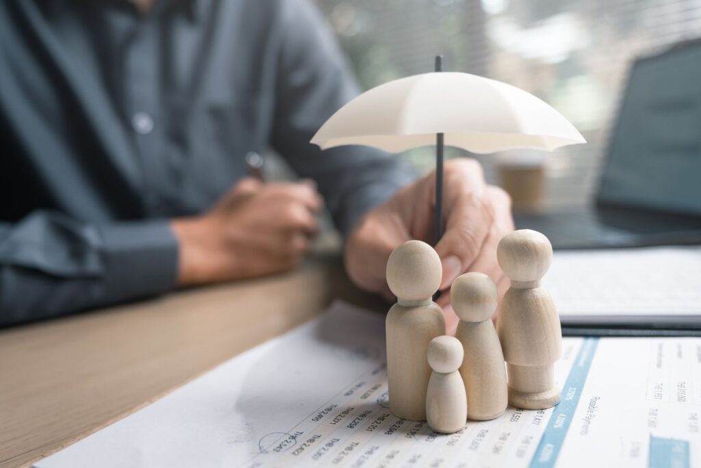 Small figures sheltered under a protective umbrella
