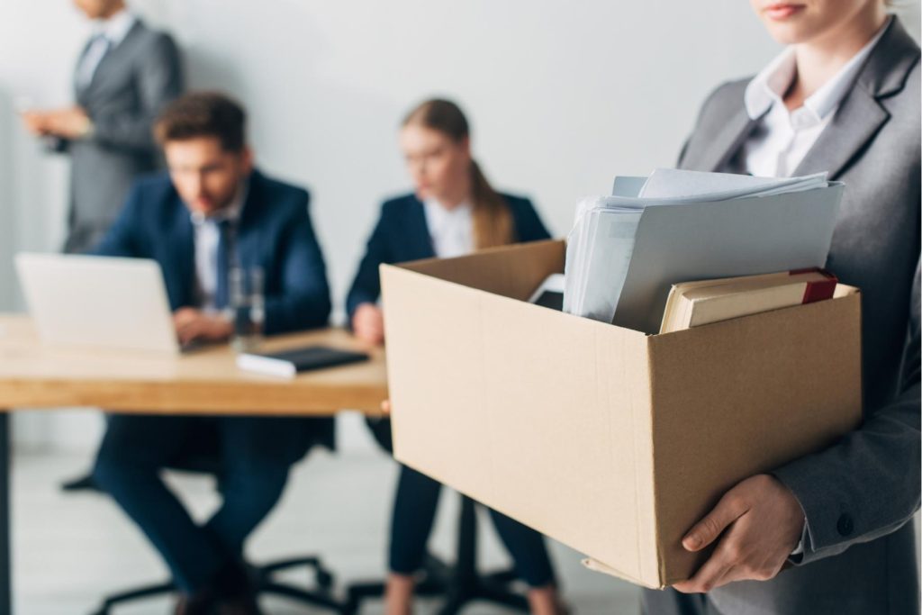 Employee carrying personal belongings from an office