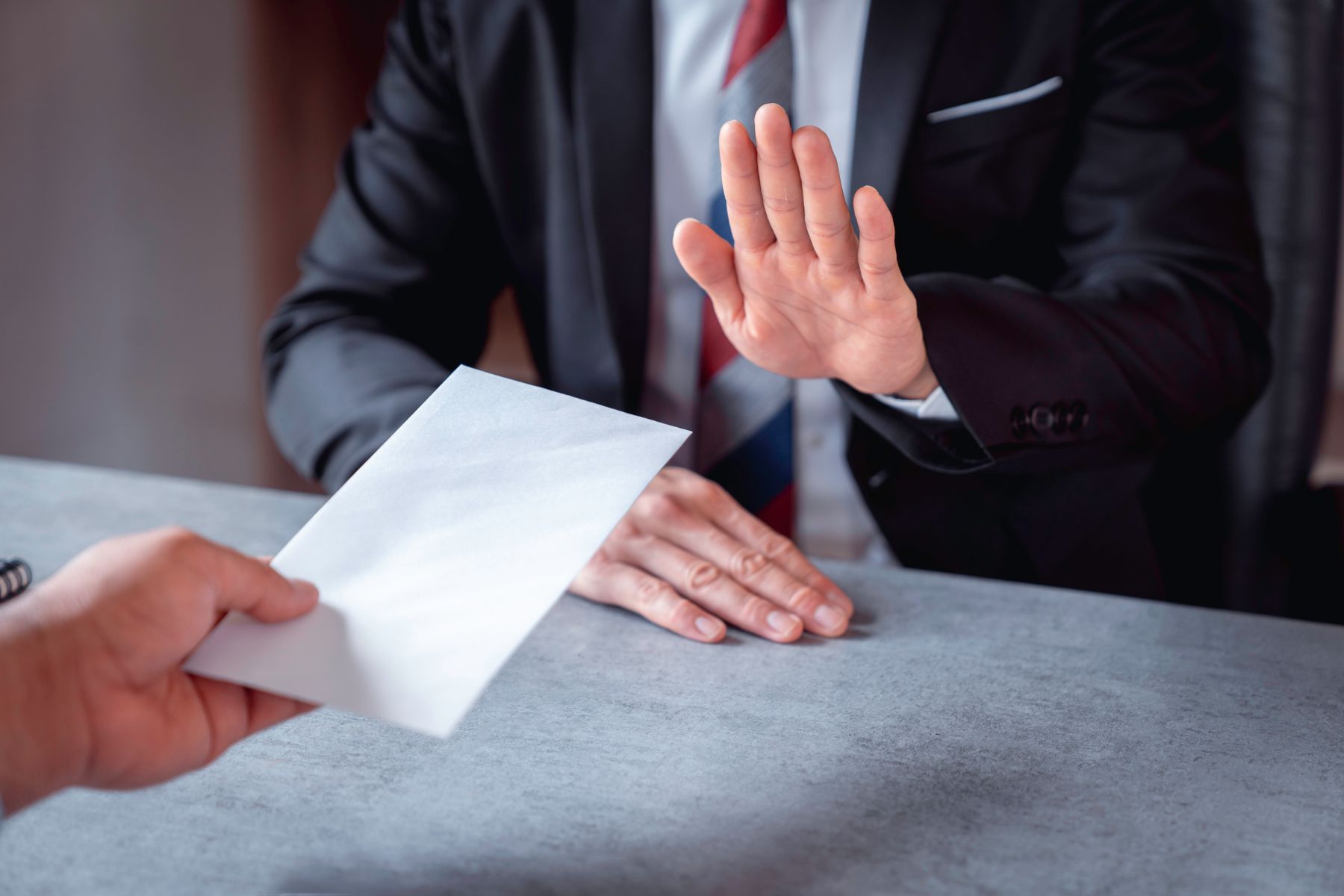 Employee raising a hand while being presented with a letter